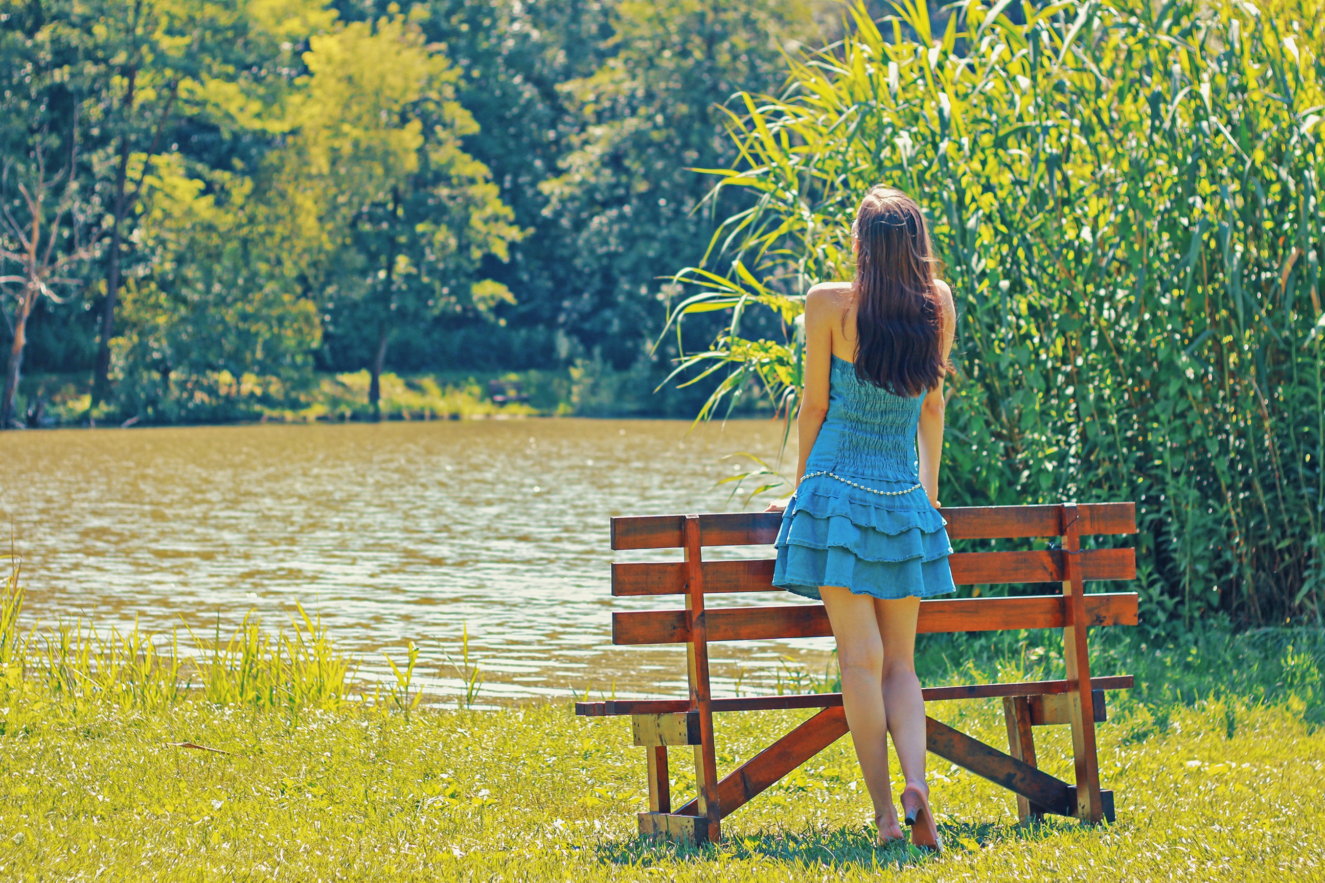 woman looking over a pond