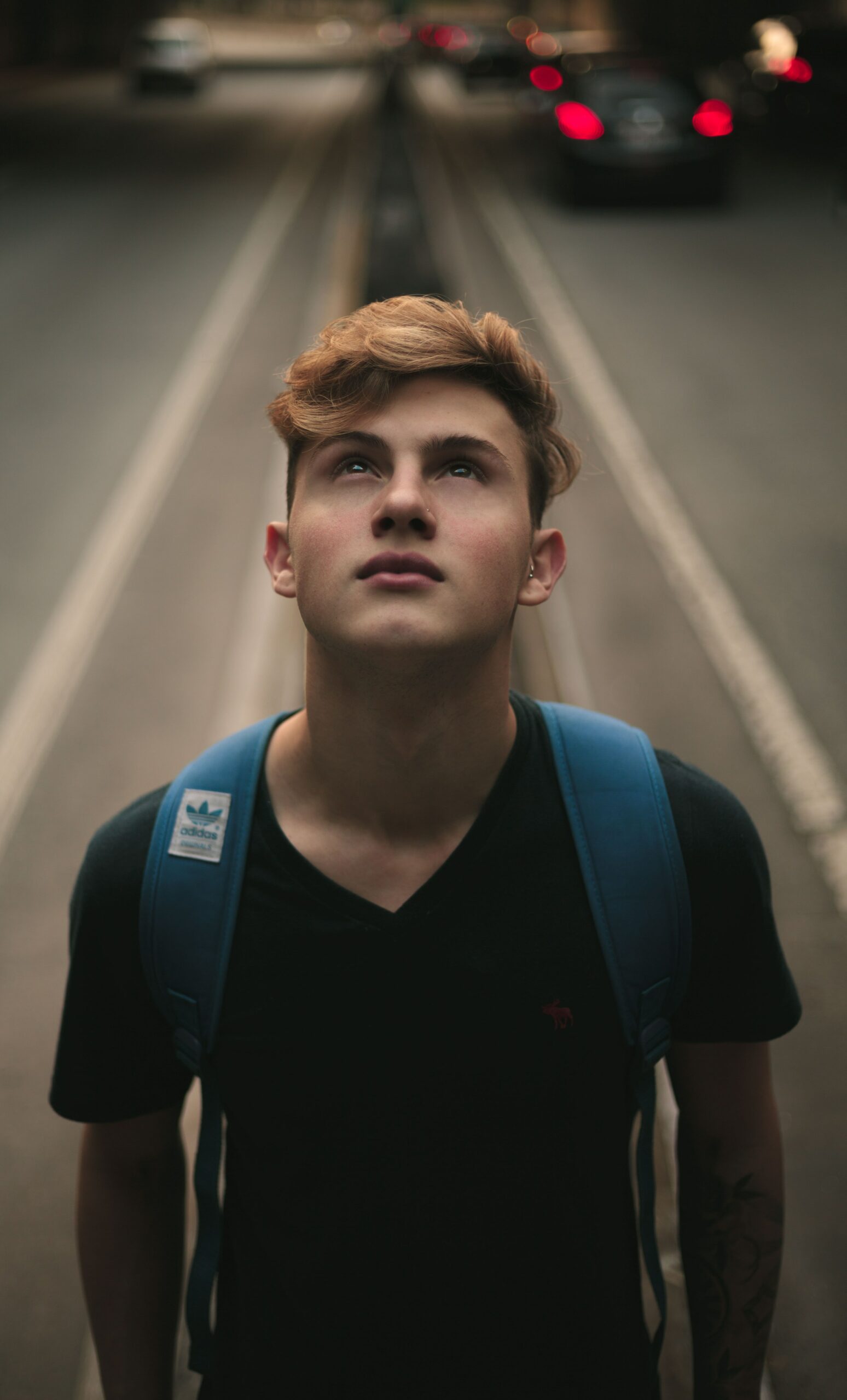 teenager standing in the middle of a road