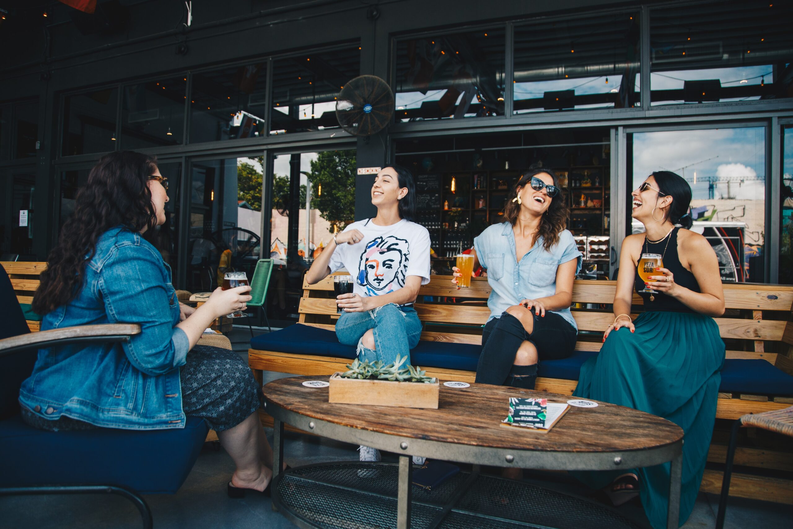 four women having a drink together