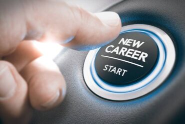 A thumb reaches forward to press a lit up button that reads “New Career” above a line and “start.”