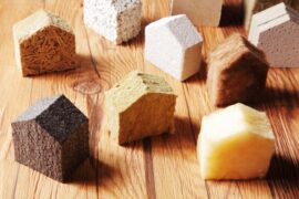 A range of different insulation types, from natural to synthetic, cut and shaped to resemble the shape of a home.
